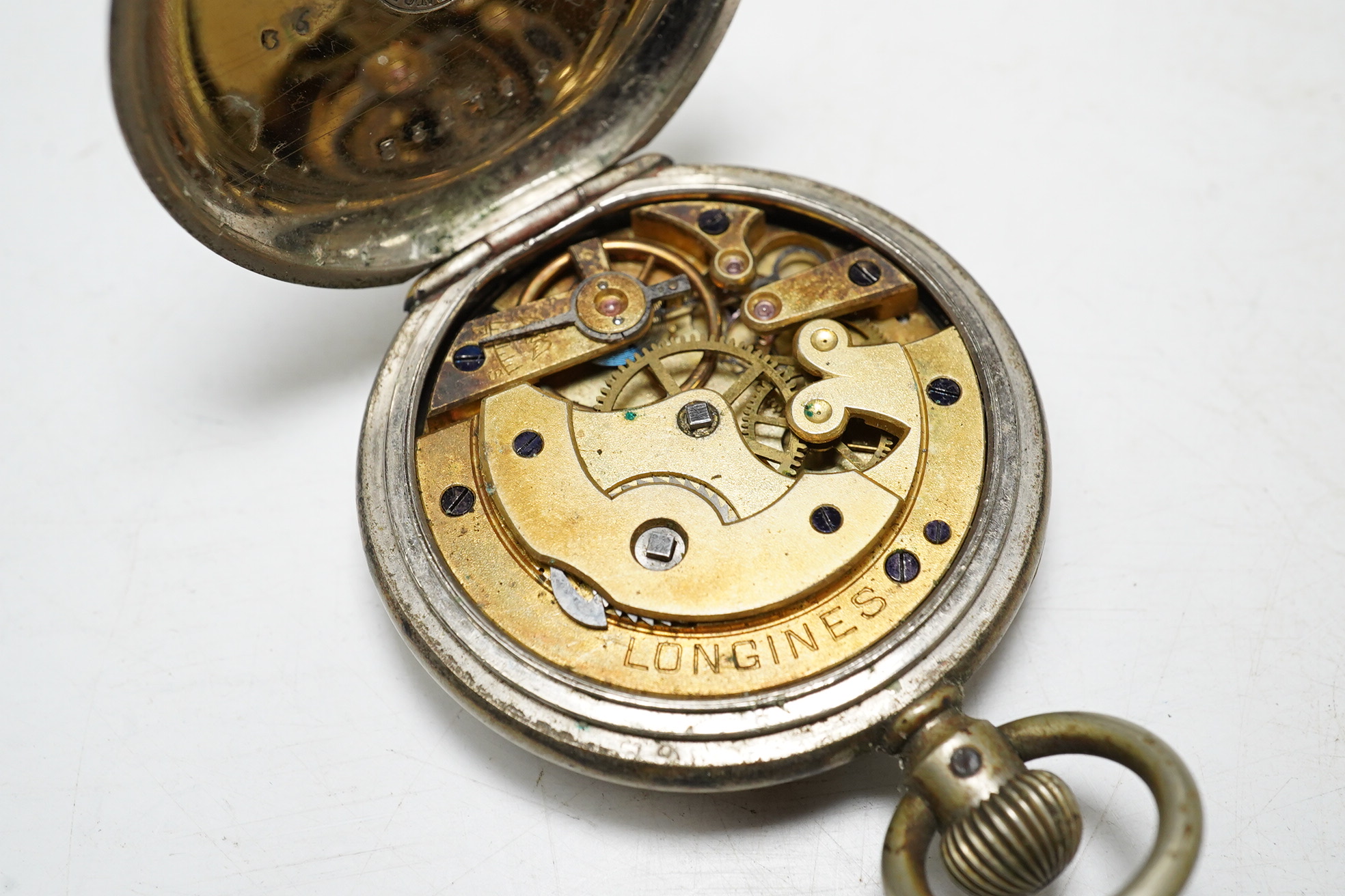 An early 20th century Longines base metal keyless pocket watch. Condition - poor, movement not going